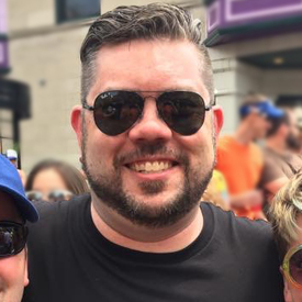 smiling man wearing sunglasses outside 